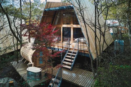 a tree house with a staircase in the middle at SANU 2nd Home 那須1st in Nasu