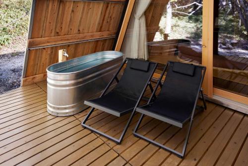 two chairs and a tub sitting on a deck at SANU 2nd Home 那須1st in Nasu