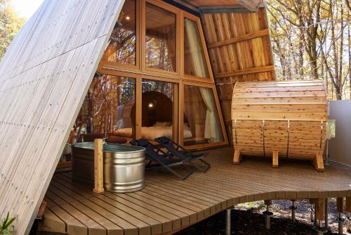 a cabin with a large window on a wooden deck at SANU 2nd Home 那須1st in Nasu