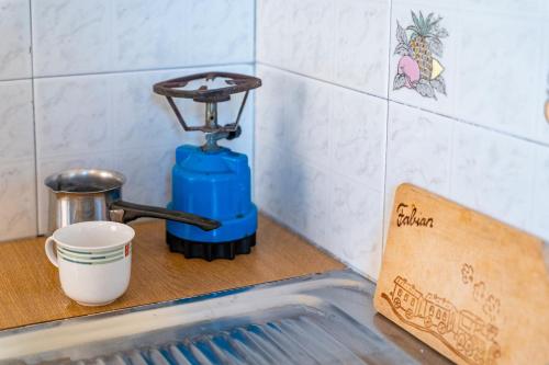 a kitchen sink with a water faucet on a counter at Alex bar apartments in Sarakiniko
