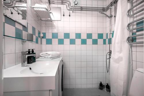 a bathroom with a sink and a shower at The Best Apartment in Stylish Sodermalm Stockholm in Stockholm