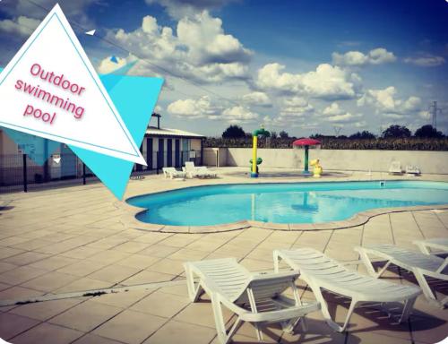 a sign that says outdoor swimming pool with two chairs and a swimming pool at Mobile-Home near to Europa Park, Rulantica in Boofzheim