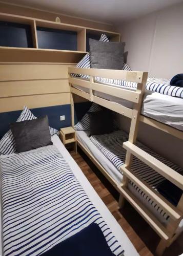a couple of bunk beds in a room at Mobile-Home near to Europa Park, Rulantica in Boofzheim