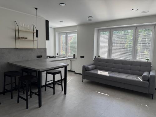 a living room with a couch and a table at New modern apartments in the centre in Narva