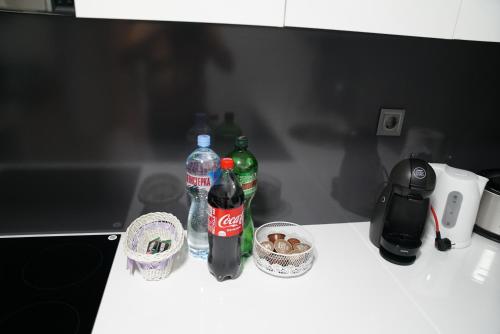 a counter with two bottles of soda and baskets of food at Skopje Sky Apartments & Floor 33th 28th & 25th & 19th & 13th 12th With Pool & Spa & Fitness & Parking Included in Price in Skopje