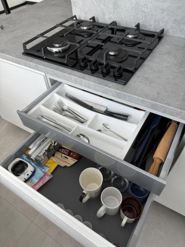 a stove top oven sitting inside of a kitchen drawer at New modern apartments in the centre in Narva