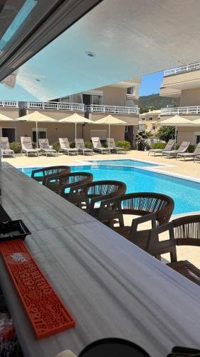 a swimming pool with chairs and a table in a hotel at Sarti Plaza in Sarti