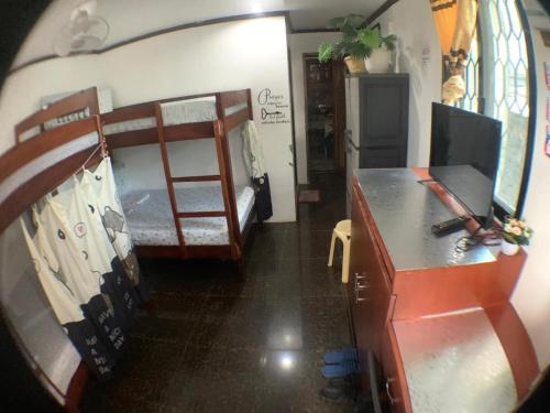 a room with two bunk beds and a desk at JML homestay in General Luna
