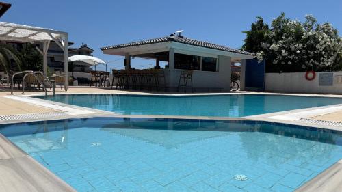 a large swimming pool in a yard with a house at Sarti Plaza in Sarti
