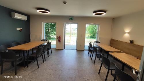 a dining room with wooden tables and chairs at Chmelnice na stezce in Napajedla