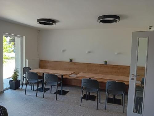 a conference room with a wooden table and chairs at Chmelnice na stezce in Napajedla