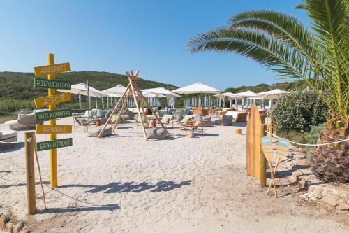a bunch of street signs on a beach at Mangia's Sardinia Resort - NEW OPENING in Santa Teresa Gallura