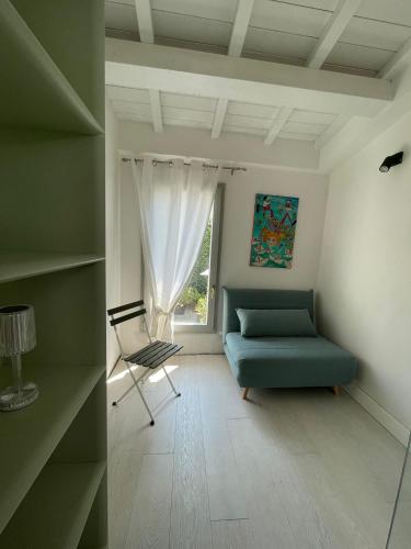 a living room with a blue couch and a chair at Canto del Grillo in Cantagrillo