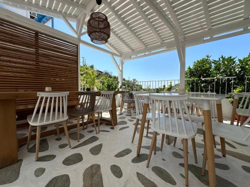 a dining room with a table and chairs on a patio at Galini Hellenic Hospitality in Patitiri