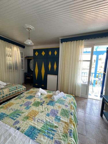 a bedroom with a bed with towels on it at Galini Hellenic Hospitality in Patitiri