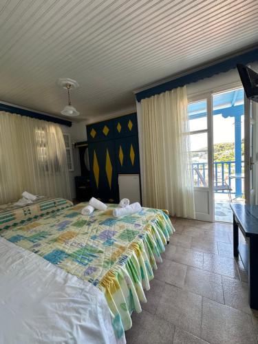 a bedroom with a bed with a colorful blanket at Galini Hellenic Hospitality in Patitiri
