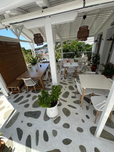 a patio with tables and chairs on a patio at Galini Hellenic Hospitality in Patitiri