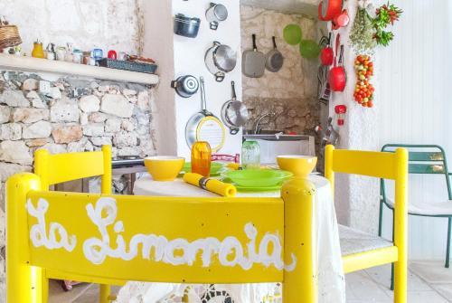 a yellow table and chairs in a kitchen at Limonaia in Salento in Marittima