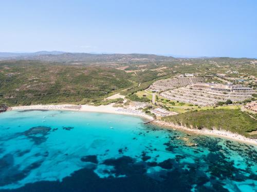 an aerial view of a beach with turquoise water at Mangia's Sardinia Resort - NEW OPENING in Santa Teresa Gallura