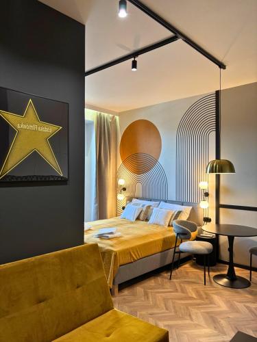 a bedroom with a bed and a star on the wall at ROOSEVELTA RESIDENCE Apartments - przy OFF Piotrkowska in Łódź