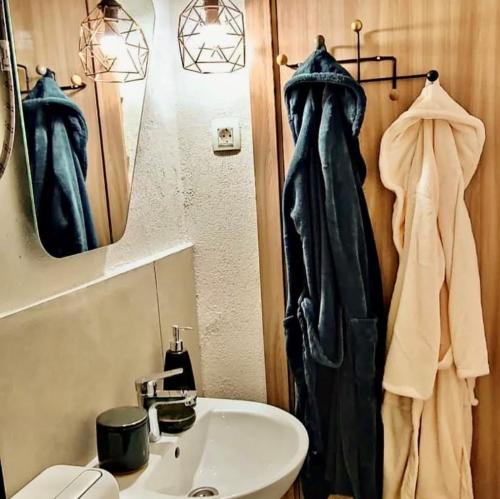 a bathroom with a sink and a toilet and a mirror at Bonaca Apartments in Budva