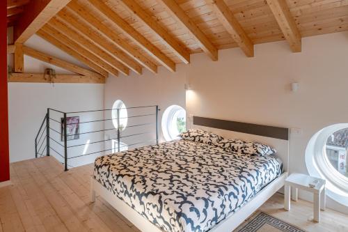 a bedroom with a bed and two windows at Casa Quadrifoglio - Ticino in Intra