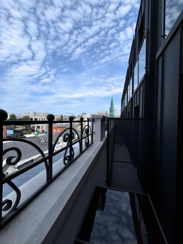 a balcony of a building with a view of a city at ROOSEVELTA RESIDENCE Apartments - przy OFF Piotrkowska in Łódź