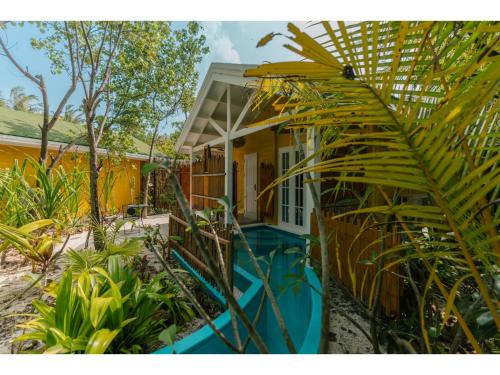 a house with a pool in front of it at Oaga Art Resort Maldives - Greatest All Inclusive Plan with Free Speedboat Round-trip in North Male Atoll