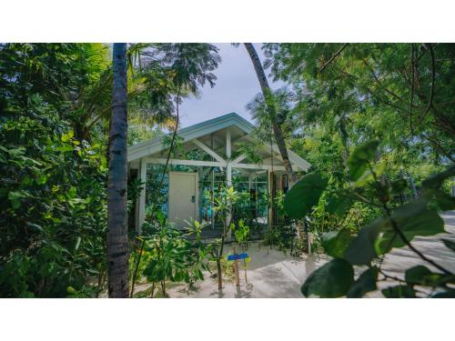 a small house in the middle of the forest at Oaga Art Resort Maldives - Greatest All Inclusive Plan with Free Speedboat Round-trip in North Male Atoll