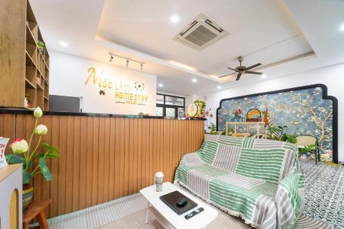a living room with a bed and a table at Moc Lam Homestay GrandWorld Phu Quoc in Phu Quoc