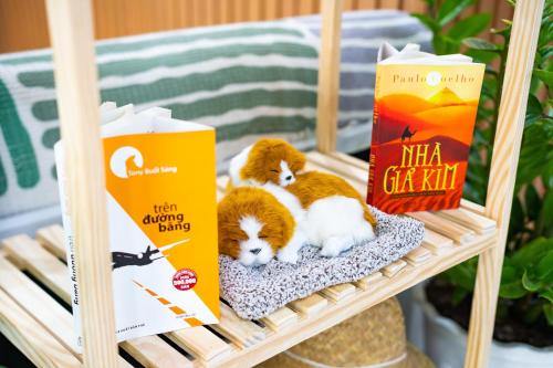 two kittens laying on a basket on a shelf at Moc Lam Homestay GrandWorld Phu Quoc in Phu Quoc
