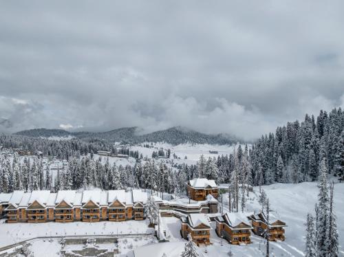 a lodge in the snow on a mountain at The Khyber Himalayan Resort & Spa in Gulmarg