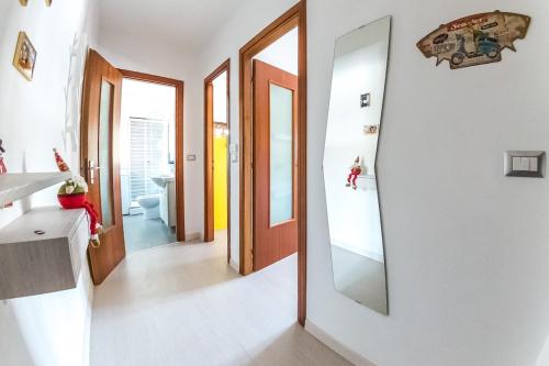 a bathroom with white walls and a mirror on the wall at Relax nel verde in Gravere