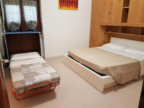 a bedroom with two beds and a bunk bed at Relax nel verde in Gravere