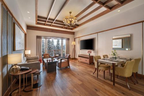 a living room with a couch and a table at The Khyber Himalayan Resort & Spa in Gulmarg
