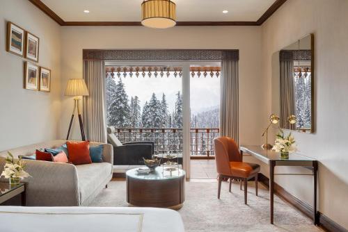 a living room with a couch and a table at The Khyber Himalayan Resort & Spa in Gulmarg