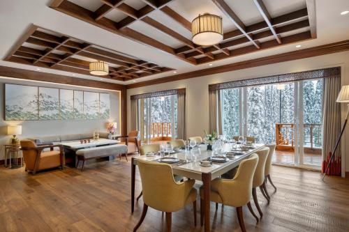 a large dining room with a table and chairs at The Khyber Himalayan Resort & Spa in Gulmarg