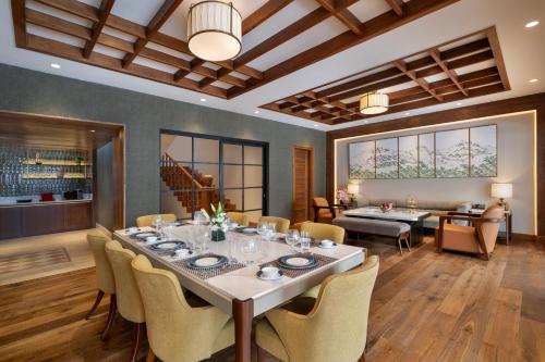 a dining room with a large table and chairs at The Khyber Himalayan Resort & Spa in Gulmarg