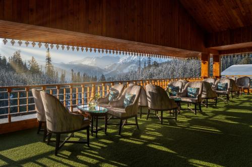 a row of tables and chairs on a balcony at The Khyber Himalayan Resort & Spa in Gulmarg