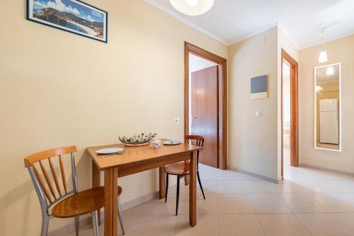 a dining room with a wooden table and chairs at Alex bar apartments in Sarakiniko