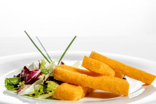 a plate of food with a salad and carrots at Albergo La Rocca in Brisighella