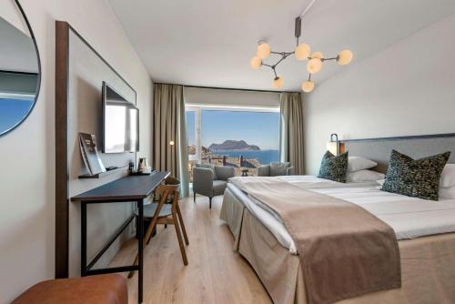a hotel room with a bed and a desk at Scandic Parken in Ålesund