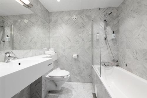 a bathroom with a toilet and a sink and a shower at Scandic Parken in Ålesund