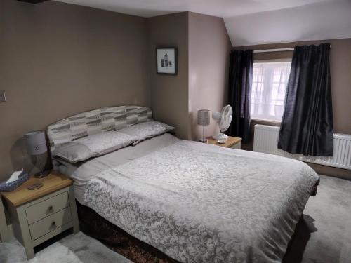 a bedroom with a bed and a window at The Wheatsheaf in Salisbury