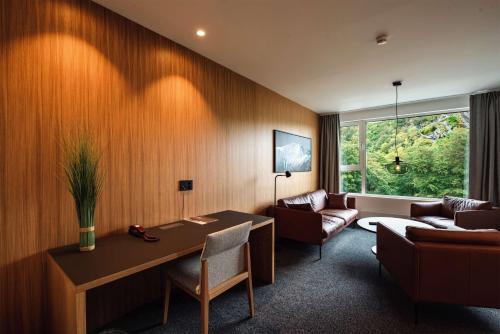 a living room with a table and a couch at Scandic Parken in Ålesund