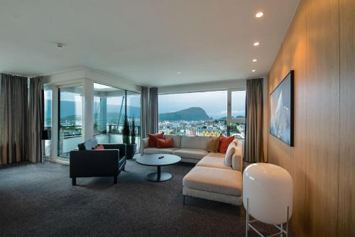a living room with a couch and a table at Scandic Parken in Ålesund