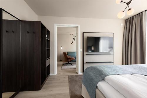 a bedroom with a bed and a television in it at Scandic Parken in Ålesund
