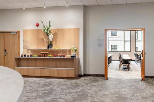an office with a reception desk and a table at Scandic Parken in Ålesund