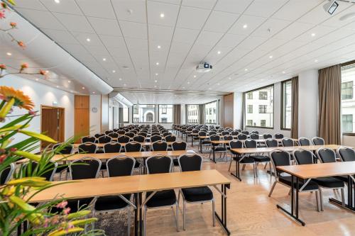 an empty room with rows of tables and chairs at Scandic Parken in Ålesund
