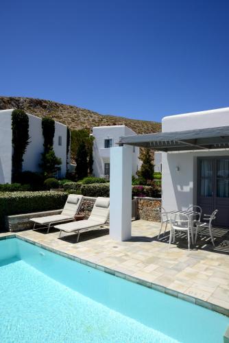 a villa with a swimming pool and a patio at ANEMI Folegandros in Karavostasi